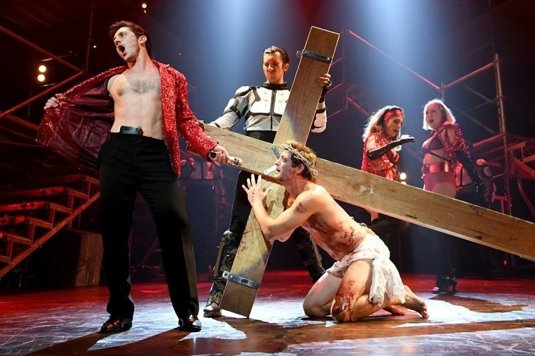 Rob Mills plays Jesus Christ Superstar, he's on stage kneeling on the floor carrying a cross on his back