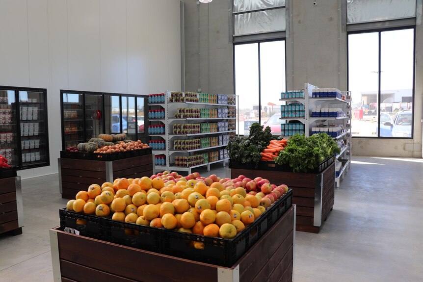 Crates of fresh food and shelves with perishable items inside Foodbank's Ballarat distribution centre 