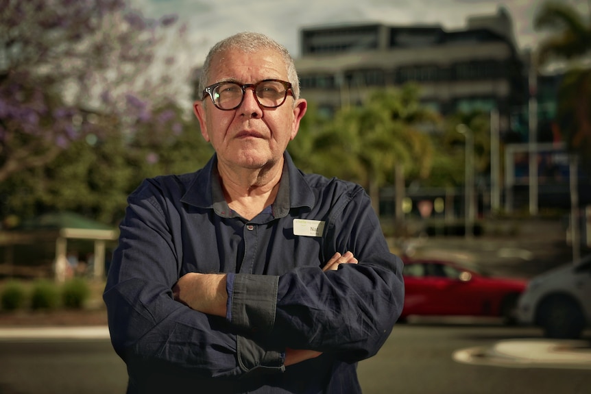 Clinical nurse Nat Karmichael stands with arms crossed looking at camera