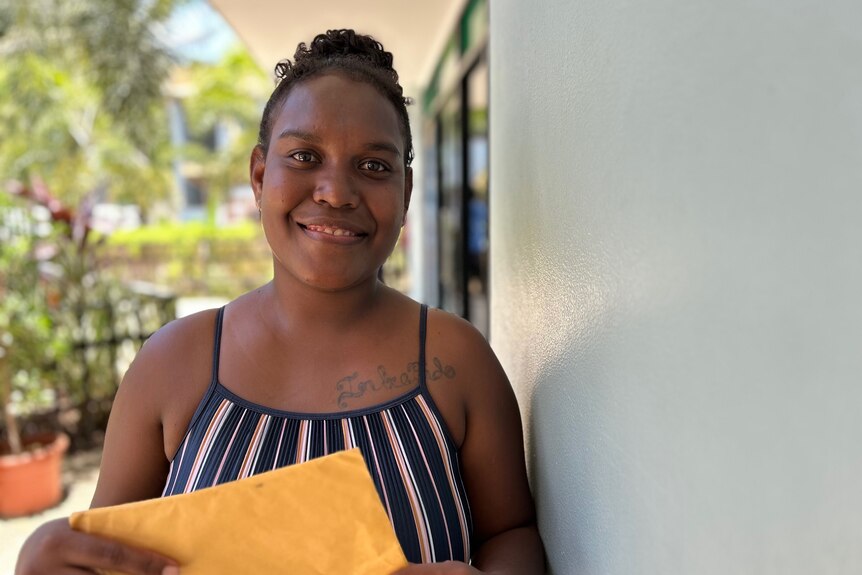 A Solomon Islaner woman holding a manila folder