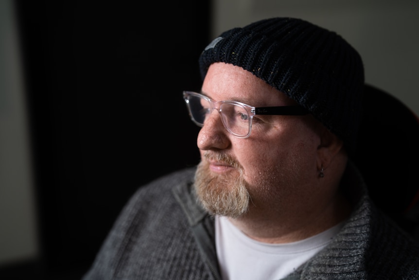 Moody portrait of a man in a faulty social housing complex.