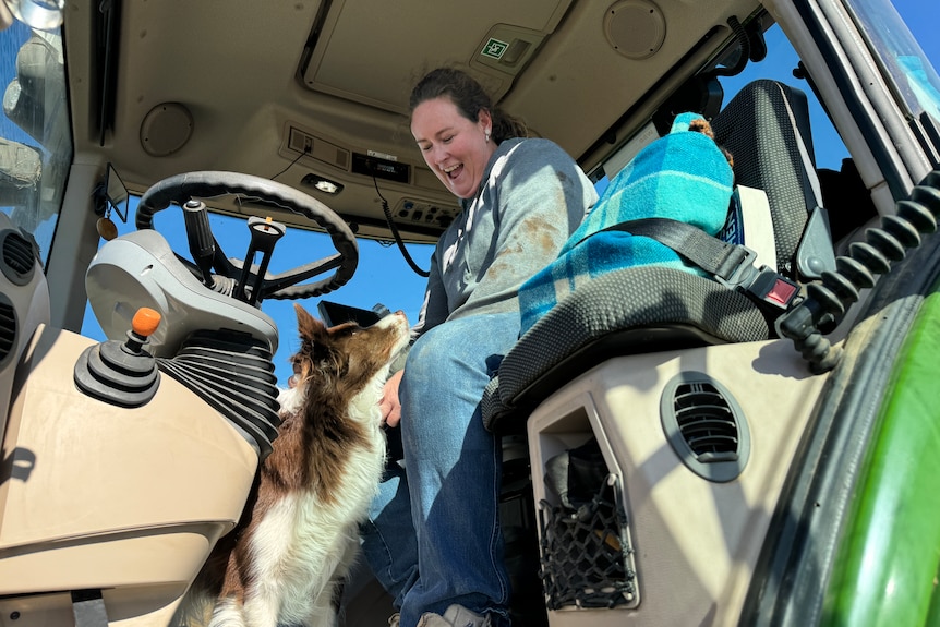 A woman and her dog in a tractor