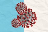 Three COVID viruses overlaid on a blue and white background