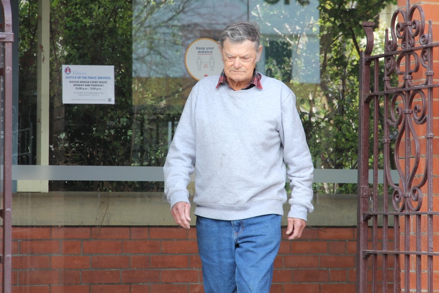 A man leaving a court house. 