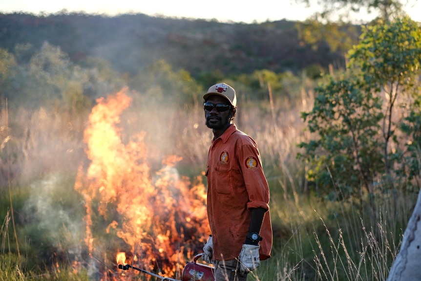 Man tends to large fire in bushland