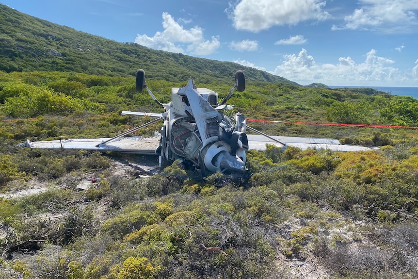 A plane rests upside down after crashing.