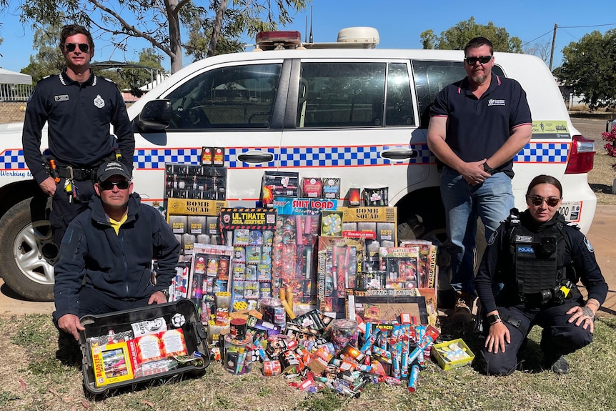 police pose next to fireworks