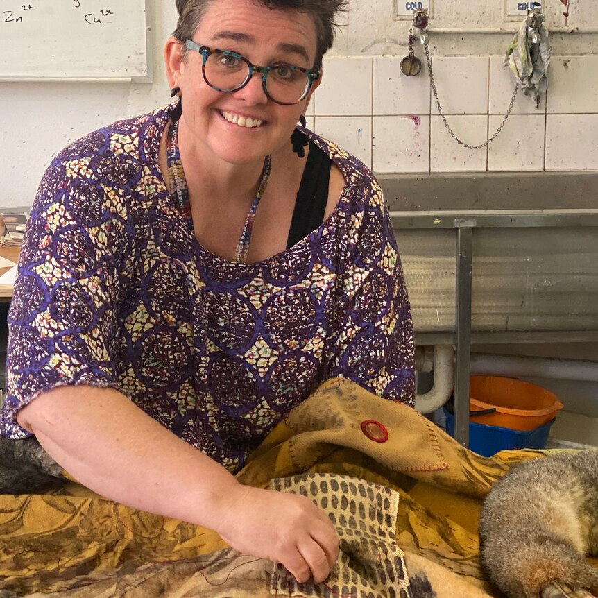 Juanita McLauchlan works on an enormous blanket artwork