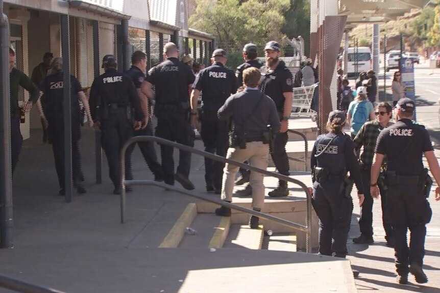 a group of about 15 police officers standing together in the cbd