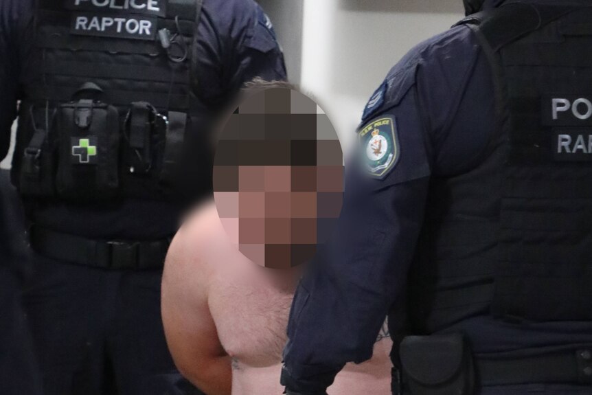 A topless man with his face blurred out surrounding by police detectives.