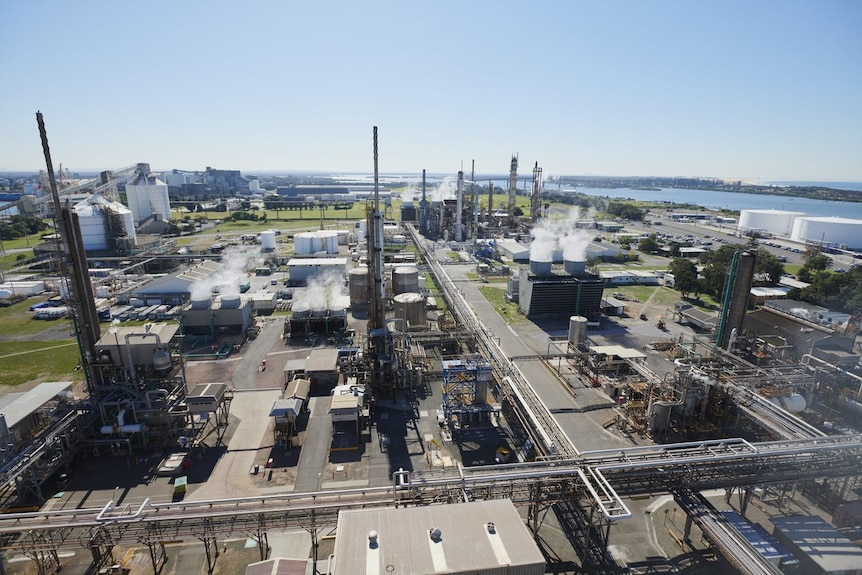 An aerial view of the plant with numerous chimneys and steam coming out of them