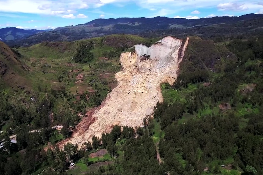 A view of the side of a mountain with a part fallen off