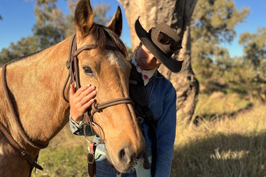 woman holding horse