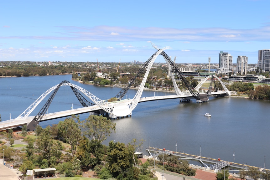 A strangely shaped bridge across a river.