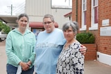 Three women standing together with angry facing in a rural town