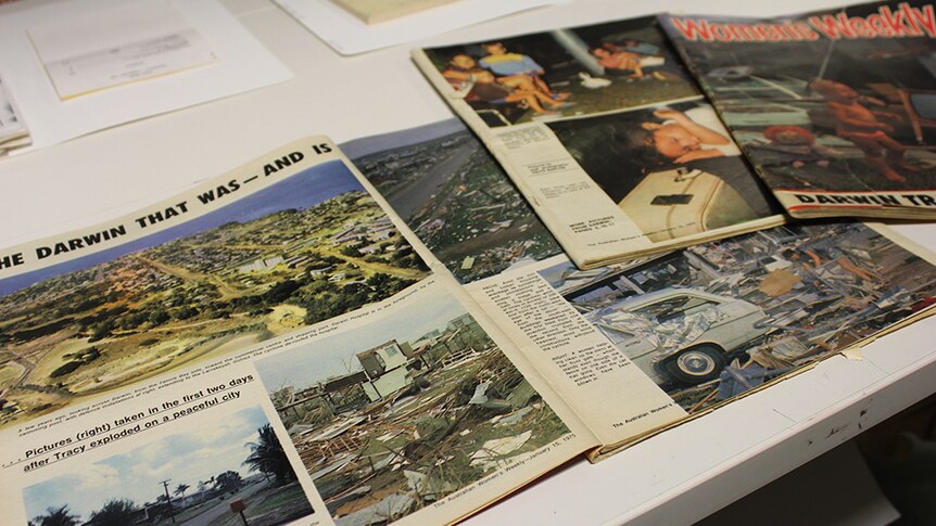 Magazine and newspaper clippings laid out on a table