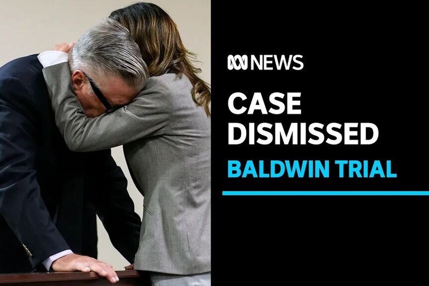 Case Dismissed, Baldwin Trial: A woman in a grey suit cradles Alec Baldwin's head in embrace.