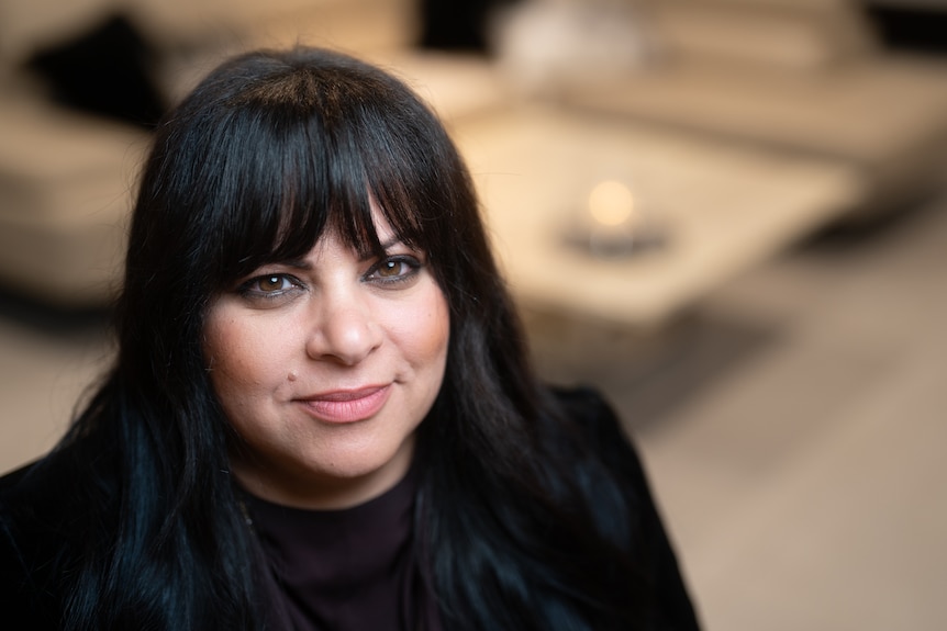 Eman Soliman in her home looks at the camera as she talks about no-fault evictions