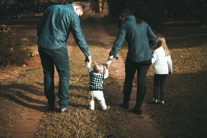 A family walking backwards.