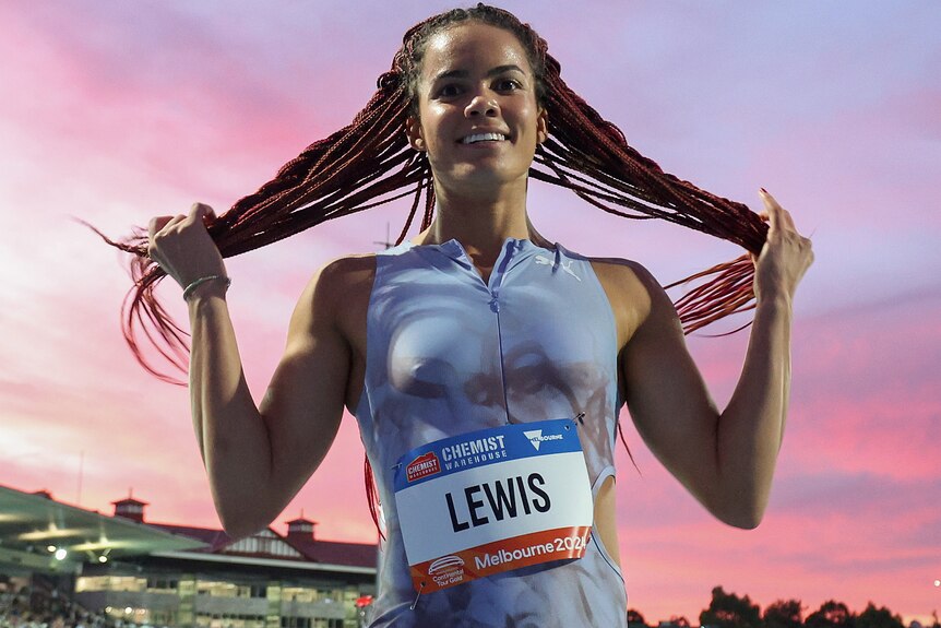 Torrie Lewis holds her hair after competing at the Maurie Plant Meet in Melbourne.