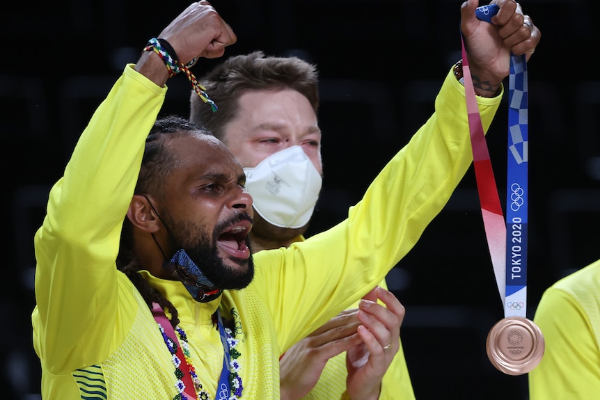 Patty Mills celebrates with the bronze medal