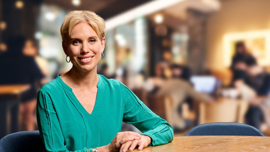 Renee Krosch sitting in a luxurious restaurant, leaning back against the back of a lounge.