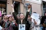 An Iranian woman living in Turkey, reacts after she cut her hair during a protest 