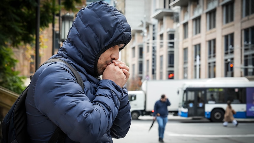 People in the streets of Sydney on a wintery day all rugged up