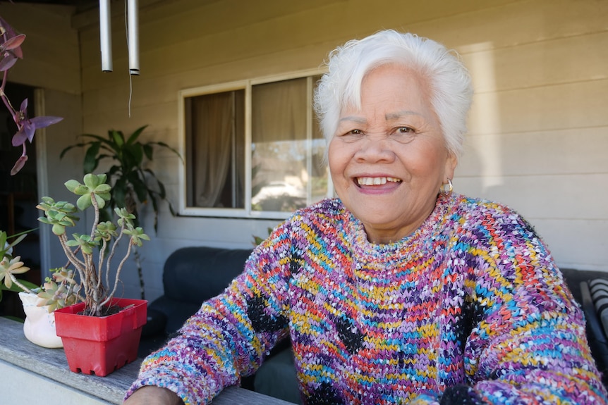 Rebecca Macdonald smiling standing on her front porch