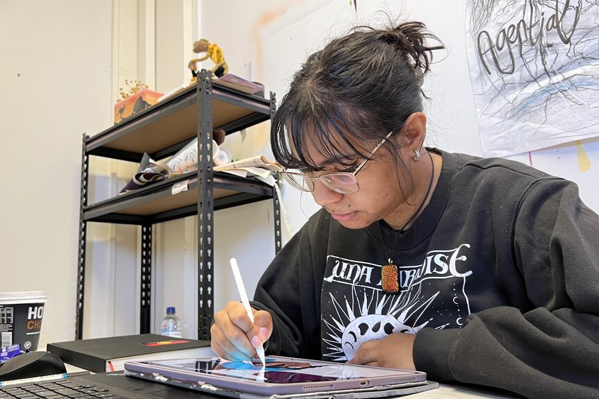 A young woman drawing on a tablet