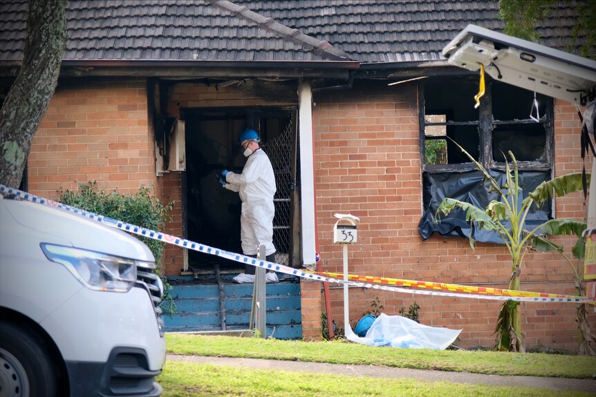 a forensic officer at the property after a fatal fire at lalor park in sydney's west claimed the life of three children