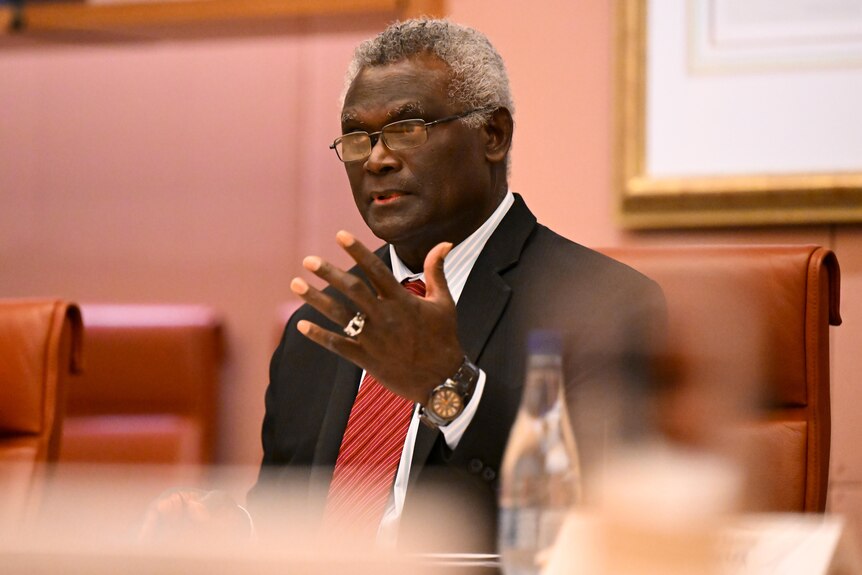 Manasseh Sogavare gestures while speaking.