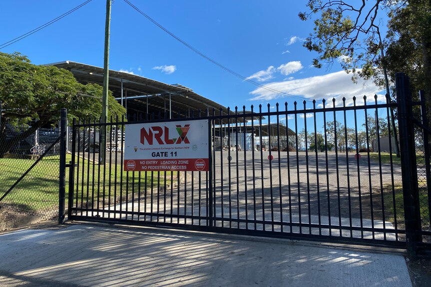 Black steel gates closed with an NRLX sign on front.