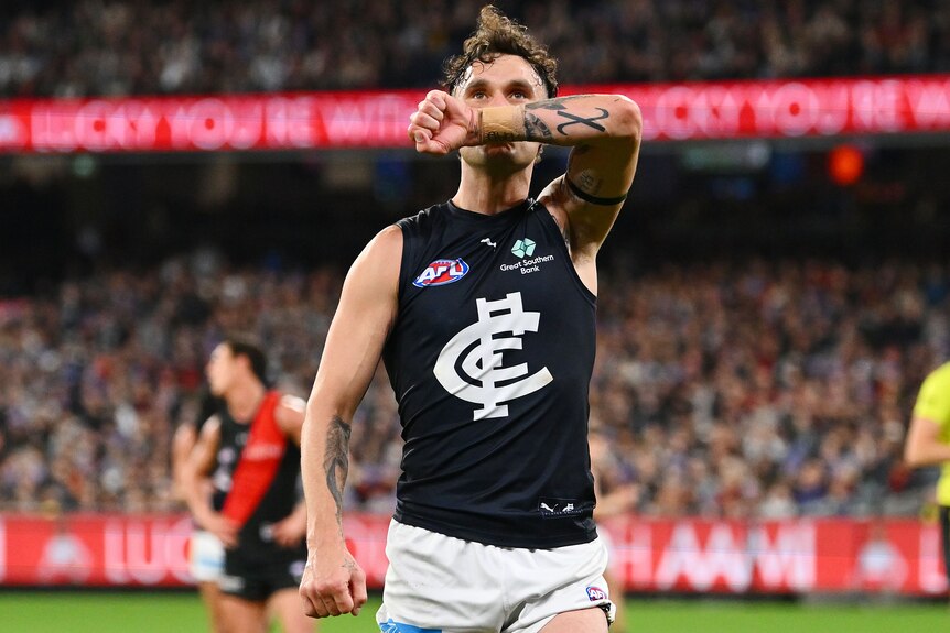 Zac Williams kisses his wrist as he pays tribute to his late sister.