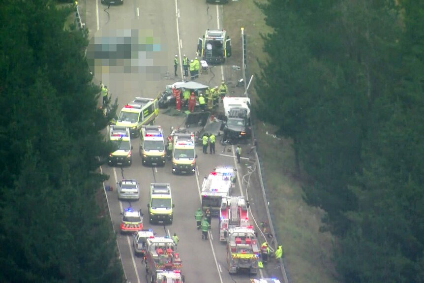 Birds eye view of several emergency services with lights on at the scene of a major crash