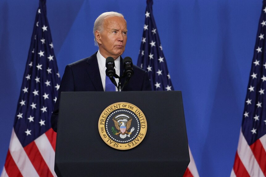 Biden stands at lecturn 