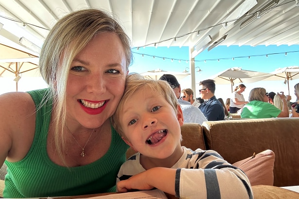 Gayle Dickerson takes a selfie with her son at a cafe table