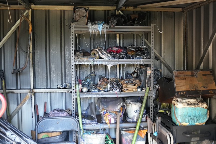 Damaged and melted equipment is seen inside a damaged Karama Community Garden shed.