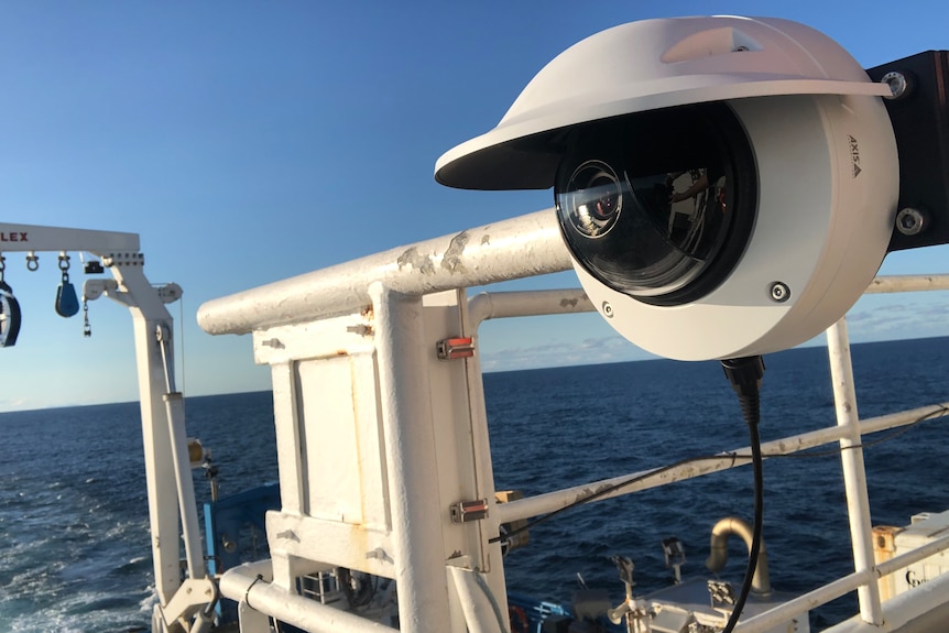 A robot that resembles a CCTV camera is attached to the front of a research vessel. 