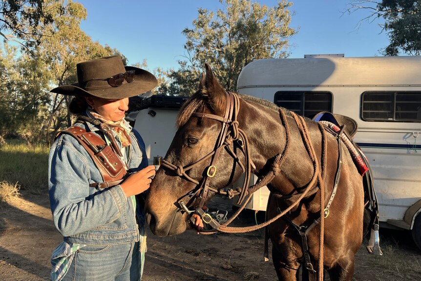 woman standing with horse