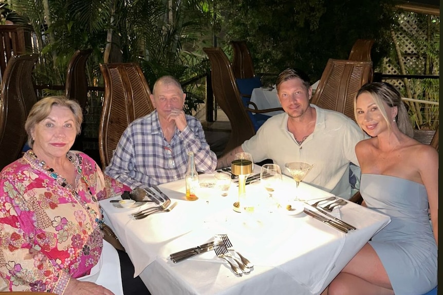 Singer John Farnham sitting at a restaurant with his wife, son, and son's wife melissa at the table with him