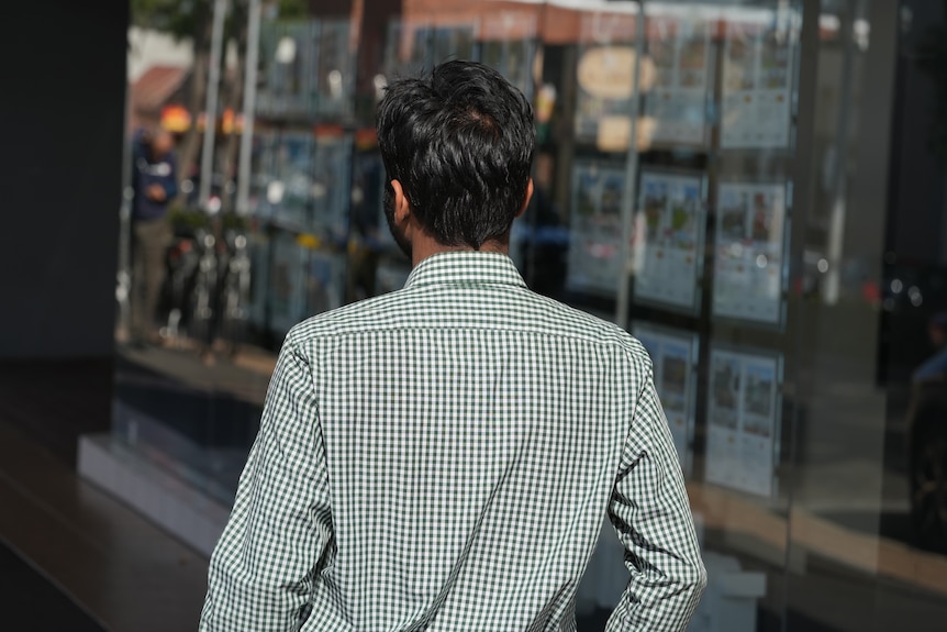 Ali Syed walks down a busy street