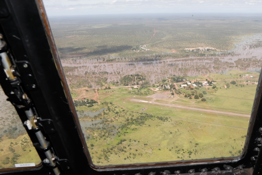 Flooding in Borroloola on Wednesday afternoon seen through the window of an ADF Spartan aircraft.