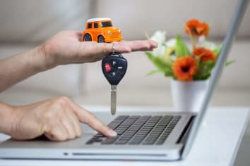 person holding a toy car in their hand