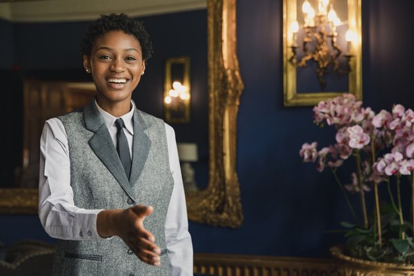 A hotel staffer greeting a guest at a hotel.