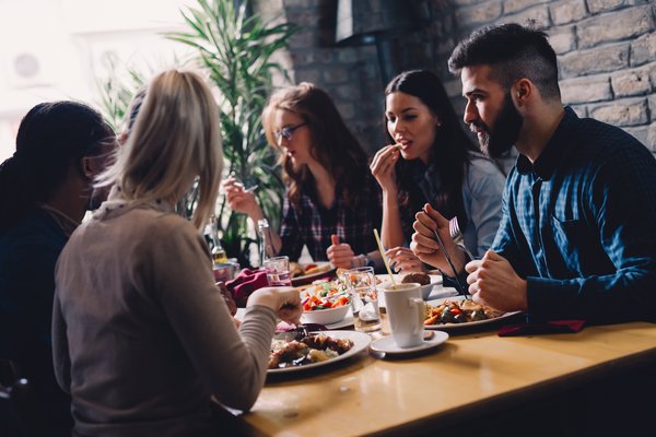 A group of people eating dinner at a casual-dining restaurant