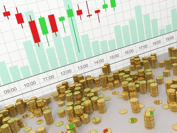 Stacks of physical crypto coins in front of a virtual currency price chart.