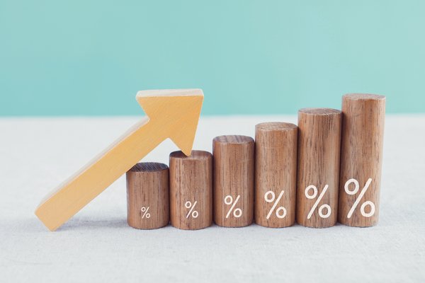 Arrow resting atop ascending wooden blocks with percentage signs also increasing in size written on them.