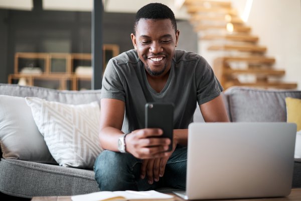 Person smiling while looking at phone.