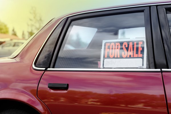 Car with a for sale sign in the window.